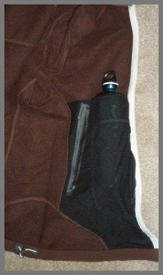 Interior pocket with top opening holding 1 qt aluminum bottle