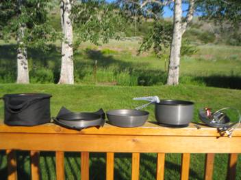 L to R: storage pouch, frying pan and cloth, windscreen, Eta-pot with gripper, base and stove
