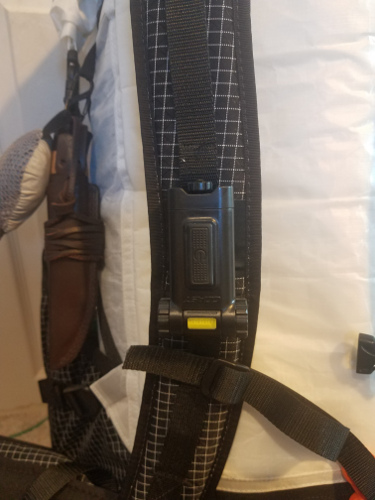 clipped to backpack strap