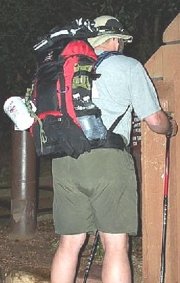 Rear view - tarps, compass, mug, para-cord, gloves, and fuel/water bottles all visible