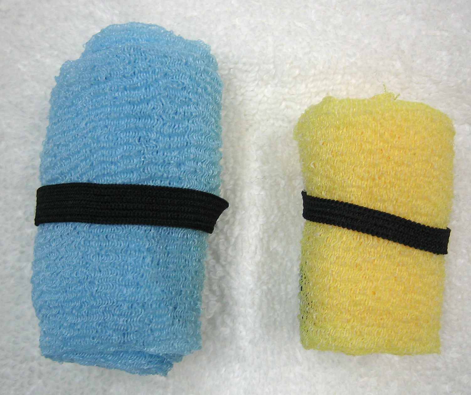 Towels rolled and secured with elastic loop
