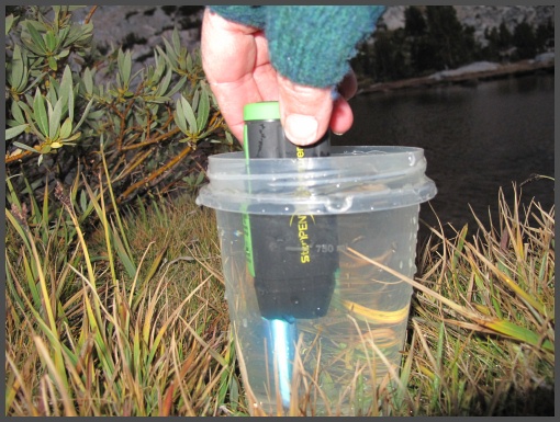Using the Ziplock container to purify water at Fletcher Lake in the High Sierras