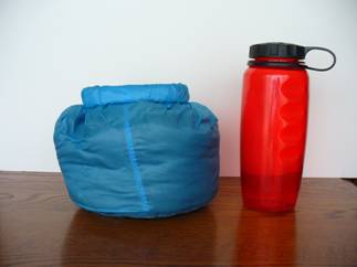 Compressed Rundle Jacket next to 1L water bottle