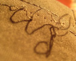 Pulled-out stitching on cuff