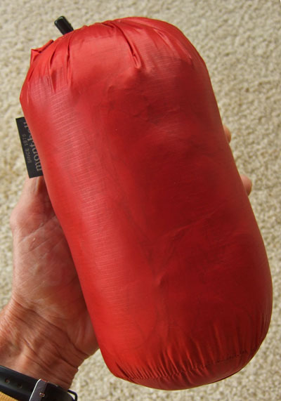 The Montbell Ex Light Down Jacket stuffed in its stuff sack measures 9 in long x 4.5 in wide (23 cm x 11 cm).