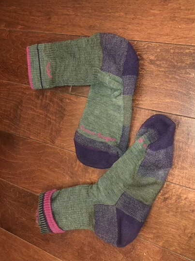 A pair of socks on a wood floor

Description automatically generated with medium confidence