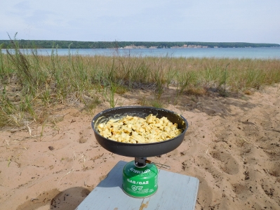 Making eggs in a frypan over the stove at Grand Island