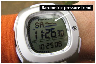 The Freestyle Nomad in TIME mode showing time, day, date, barometric pressure trend, and a second-hand cycle around the outer edge.