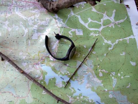map with stick and watch.