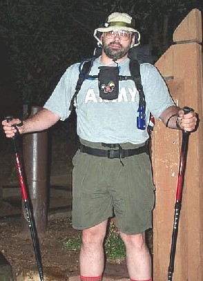 Front view - hydration hose visible.  Also note camera pouch on sternum strap and walkie talkie on thumb loop.