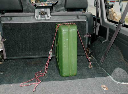 The jerry can lashed down in the back of my car.
