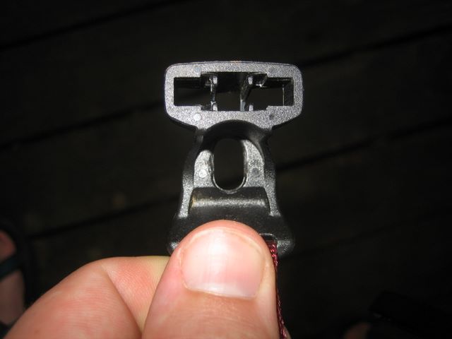 Dual purpose clip. The clip is attached to the tent and holds the ends of the poles and the clips that hold on the fly.