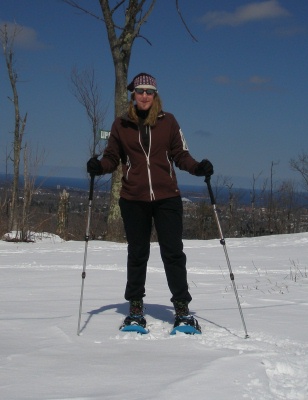 Tester snowshoeing near top of ski hill